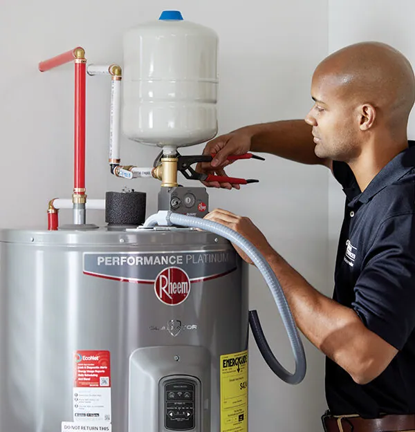 Technician installing an electric water heater