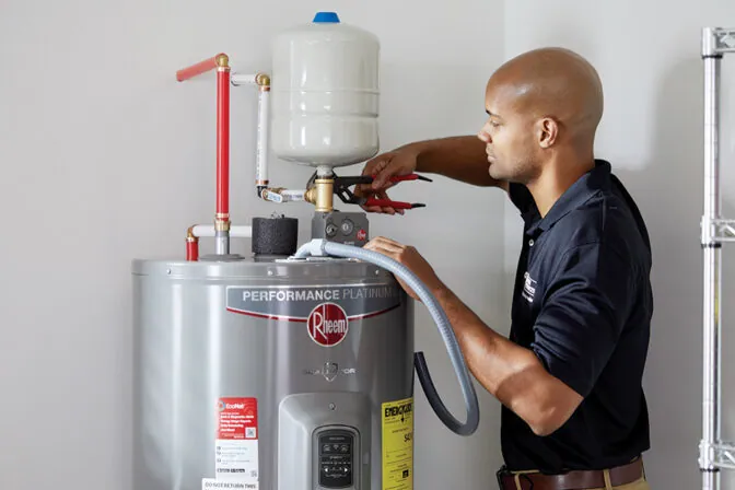 Technician installing an electric water heater